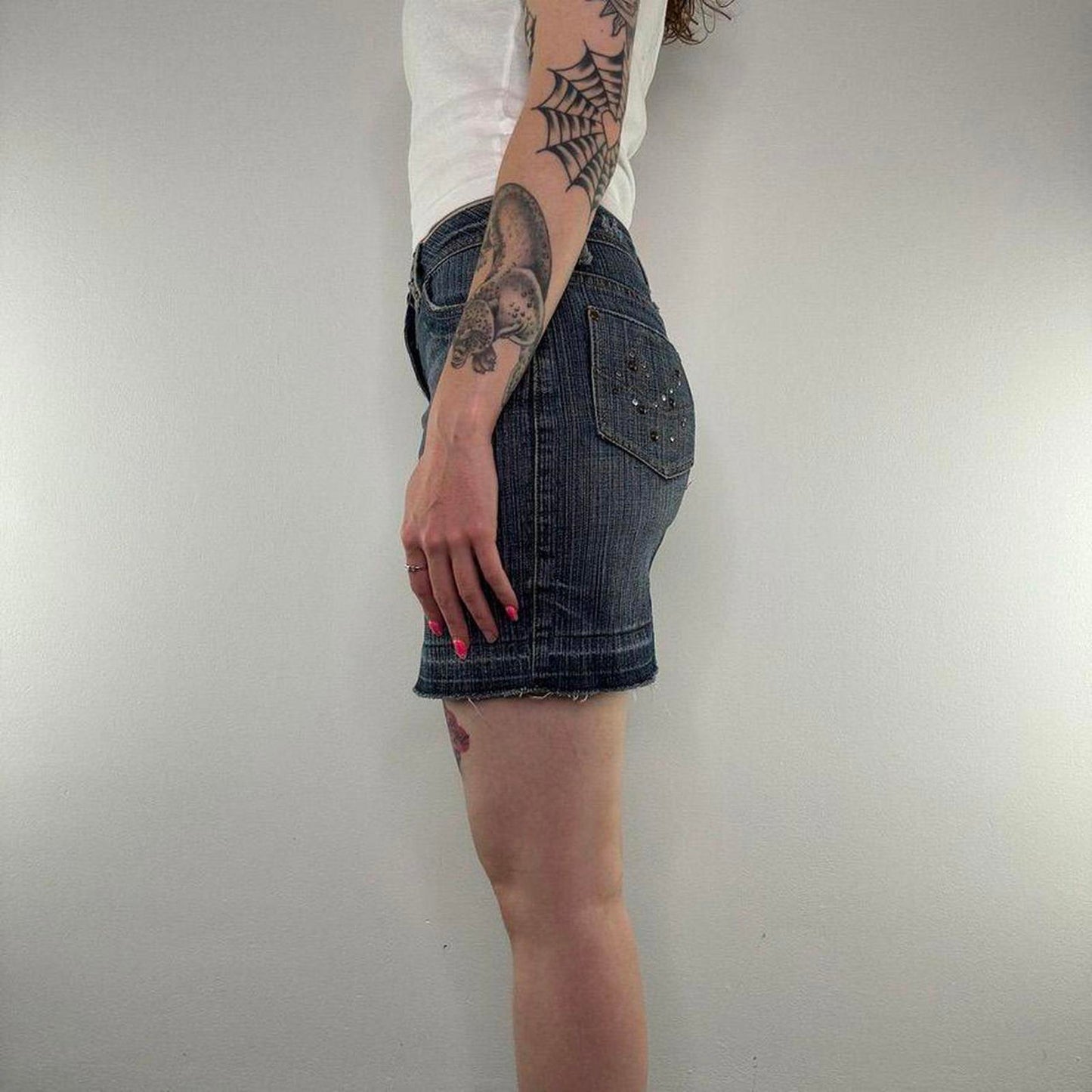 Y2K vintage studded mini skirt faded denim fraying hem embellished dark blue