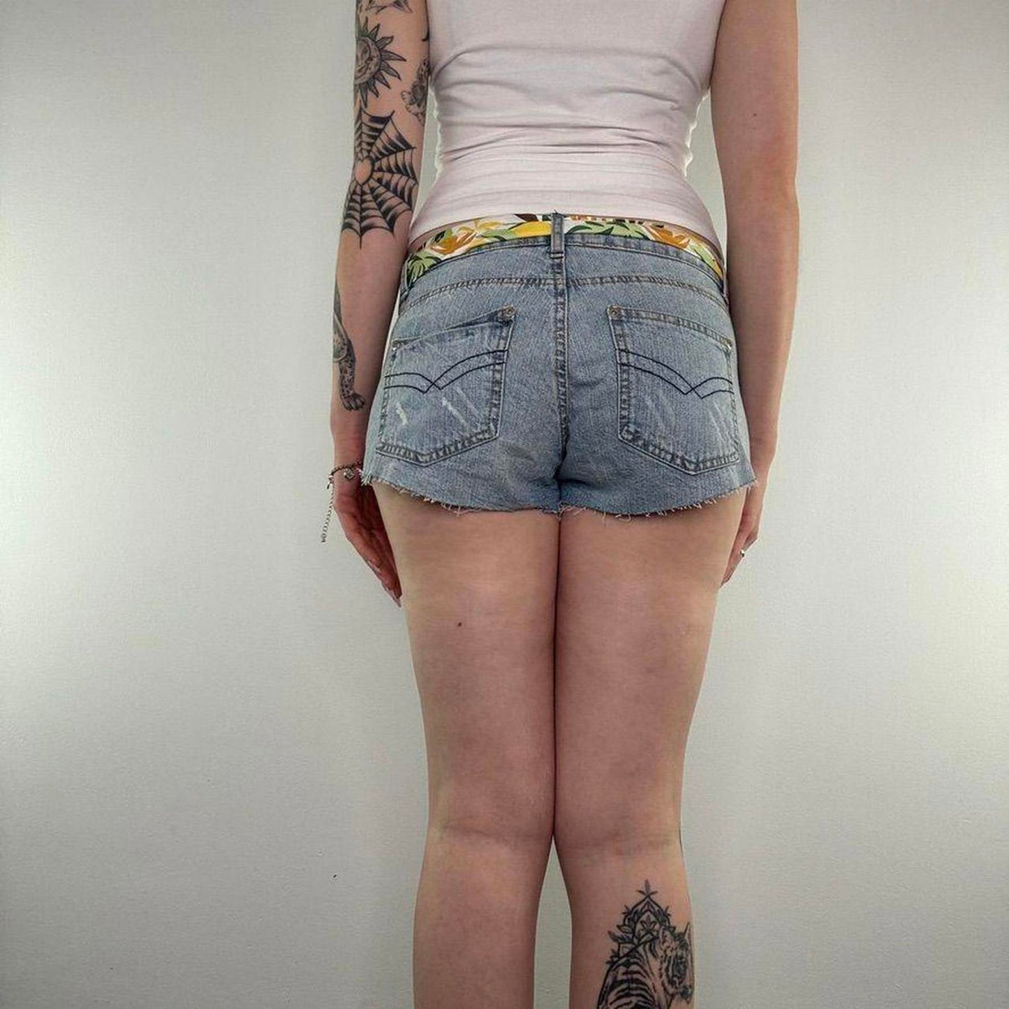 Y2K vintage low rise raw hem mini denim shorts with sunflower bow belt