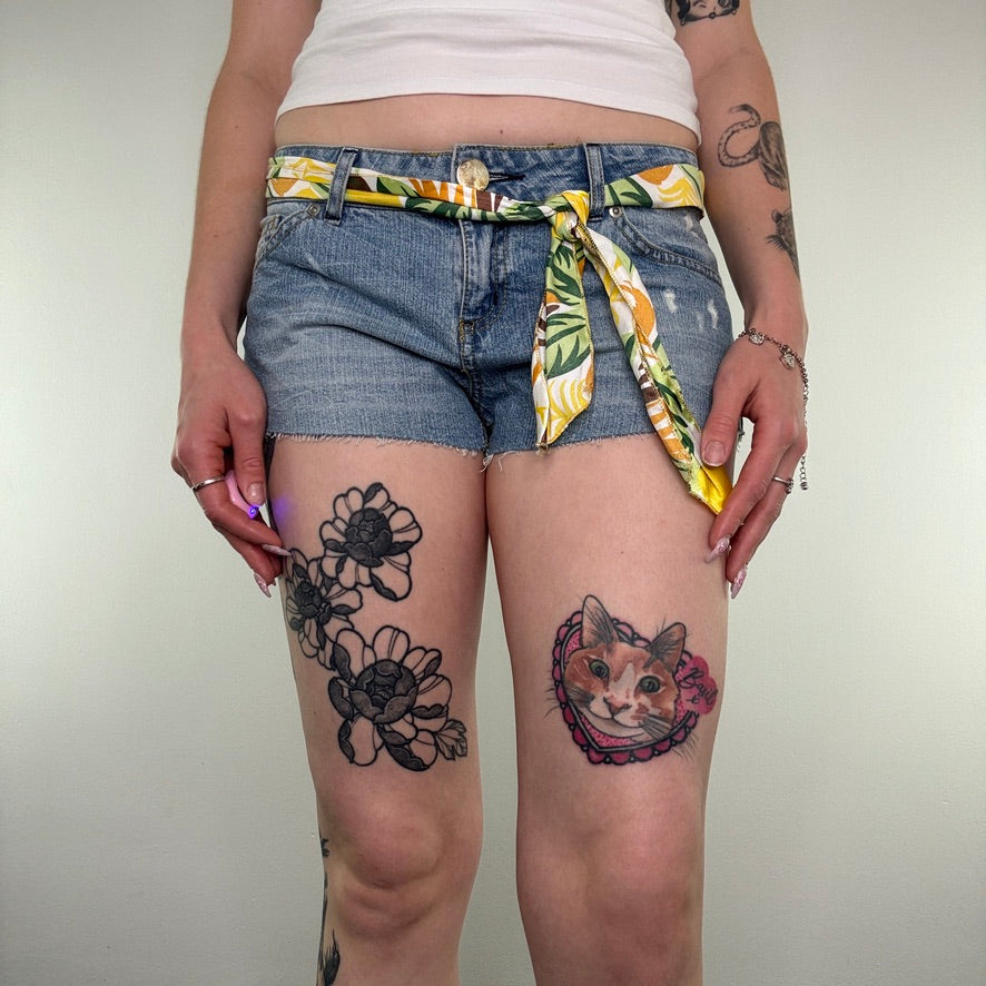 Y2K low rise raw hem mini denim shorts with sunflower tie belt