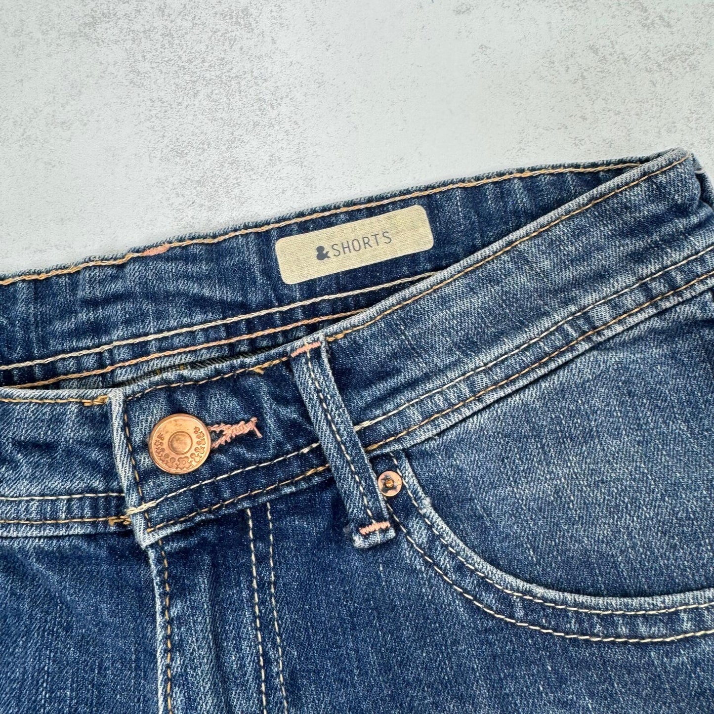Y2K vintage low rise denim mini shorts cargo turn up hem faded blue stretchy