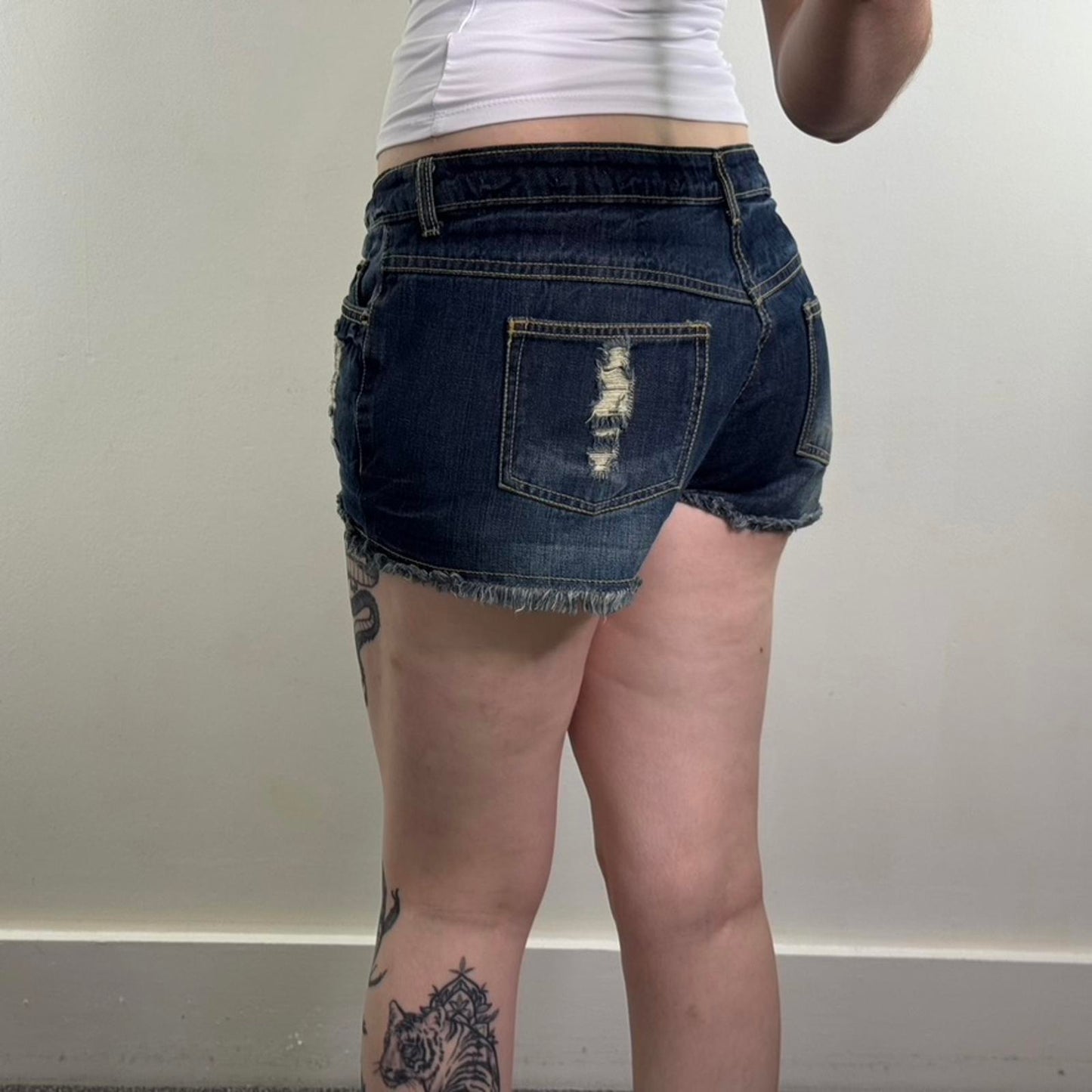 Y2K vintage low rise denim mini shorts distressed fraying hem ripped dark blue