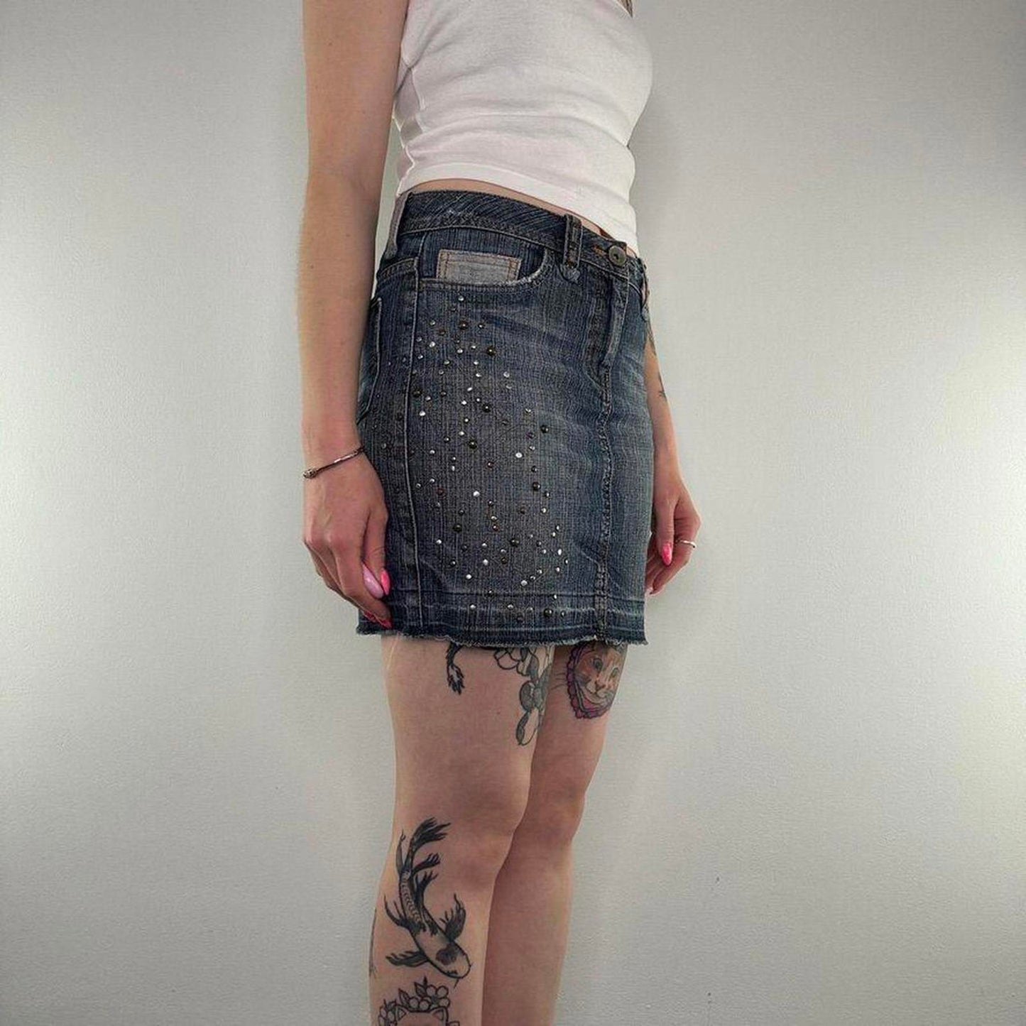 Y2K vintage studded mini skirt faded denim fraying hem embellished dark blue