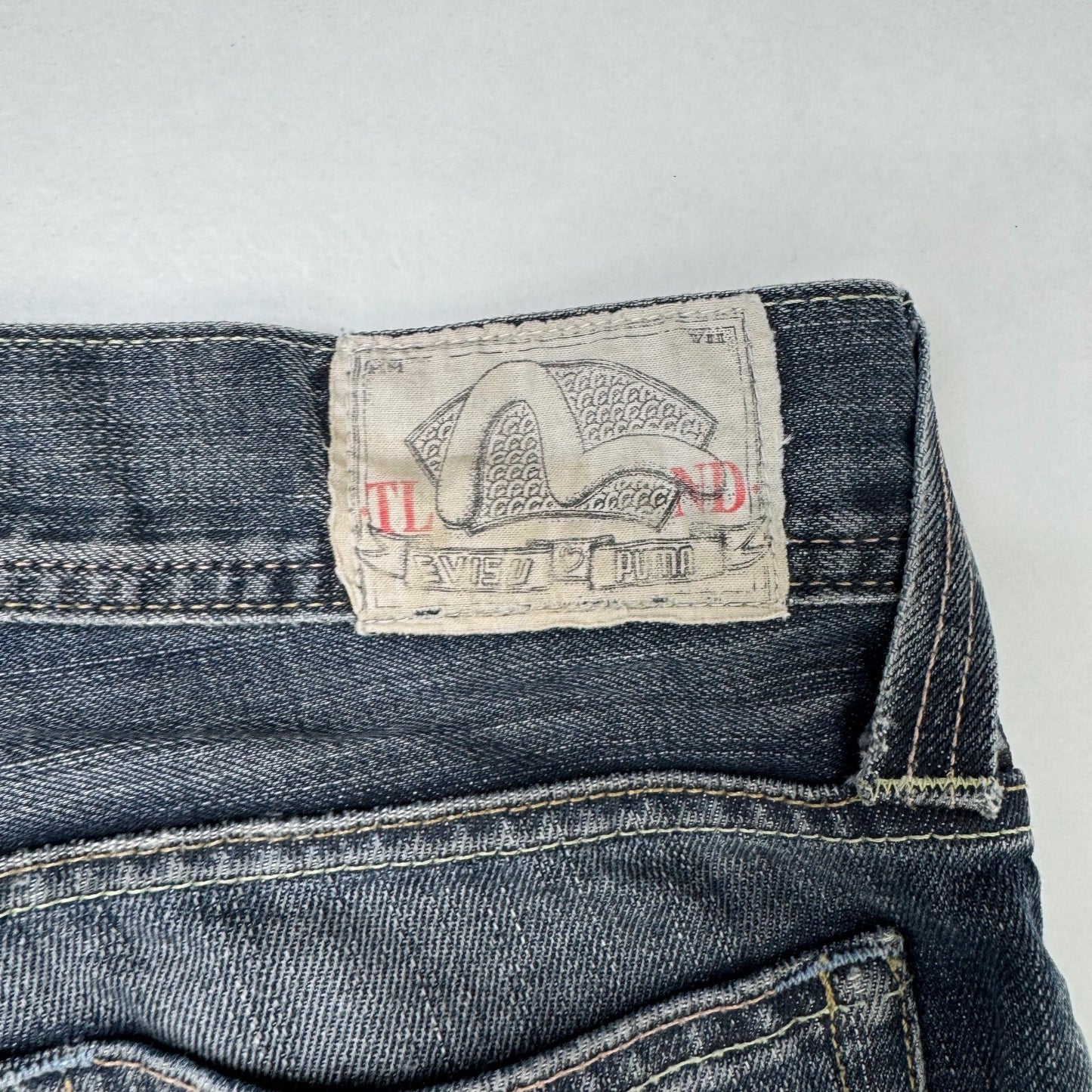 Y2K vintage Evisu x Puma bootcut jeans dark faded denim wash distressed