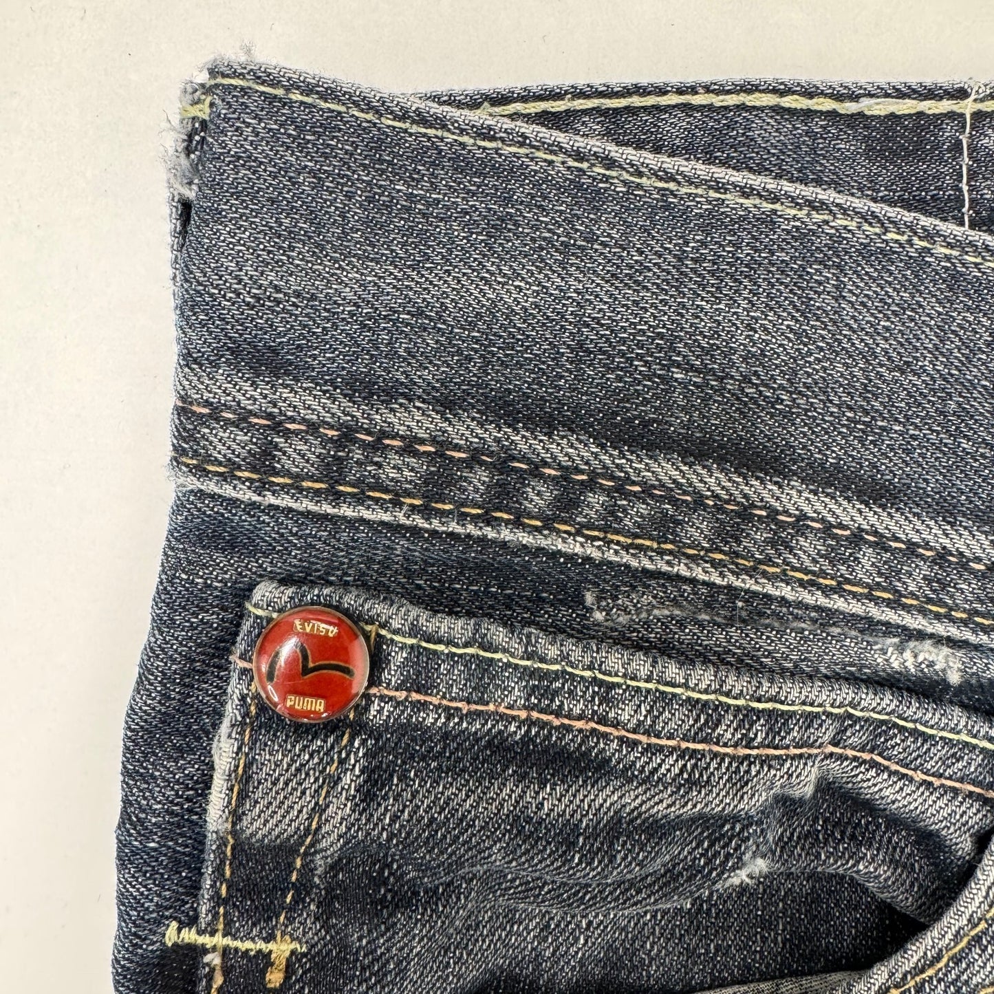 Y2K vintage Evisu x Puma bootcut jeans dark faded denim wash distressed