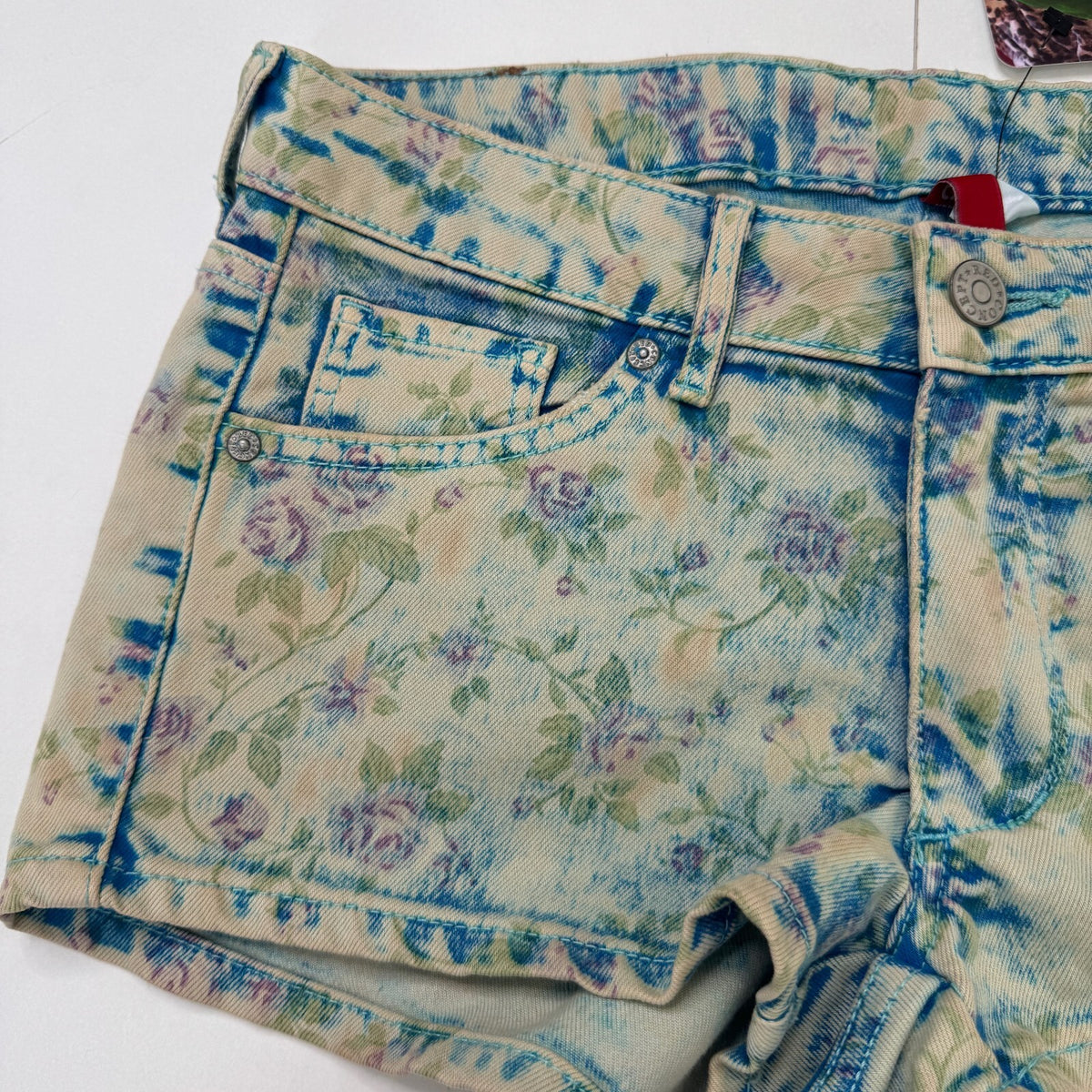Vintage 2010s denim mini shorts low rise floral faded pattern boho stretchy