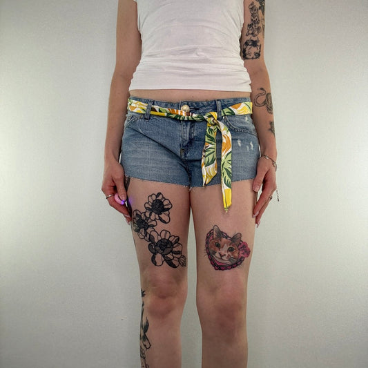 Y2K low rise raw hem mini denim shorts with sunflower tie belt